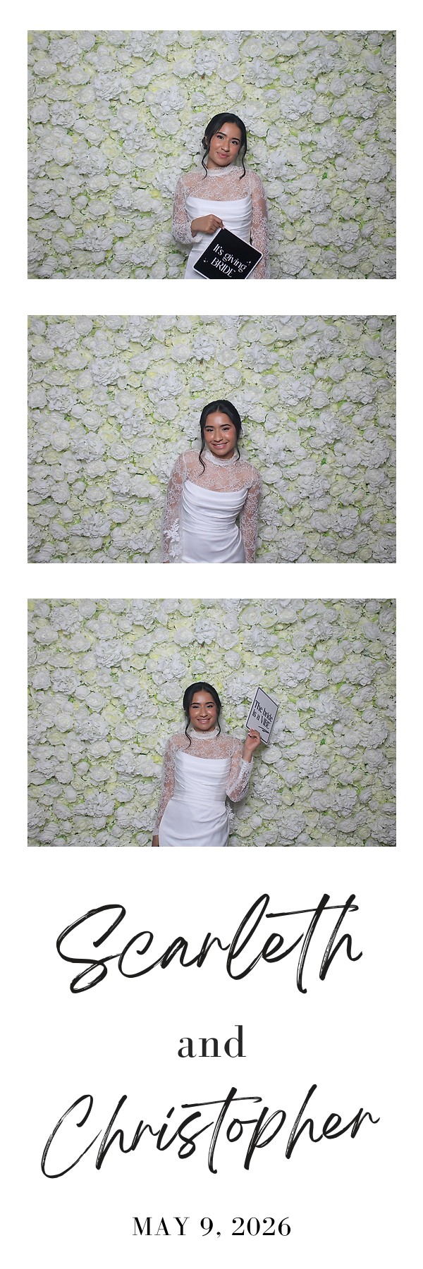 Bride posing in front of a white flower wall